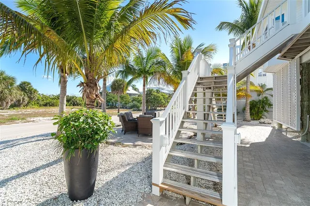 a dining hall with stainless steel appliances granite countertop a dining table chairs and granite counter tops