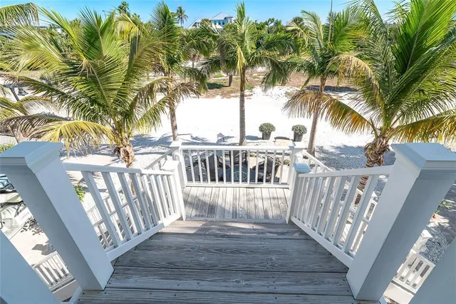 a kitchen with stainless steel appliances granite countertop a refrigerator a stove and white cabinets with wooden floor