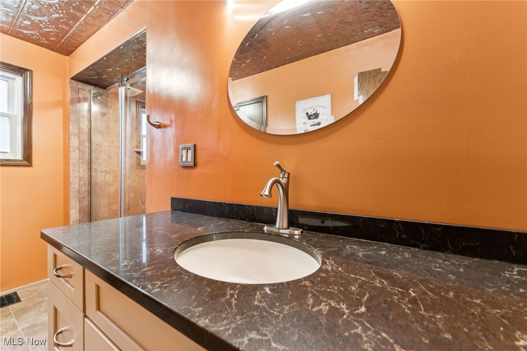 12422 Portage Street Rittman, OH 44270 - Photo 18 of 42 Bathroom featuring vanity and an ornate ceiling