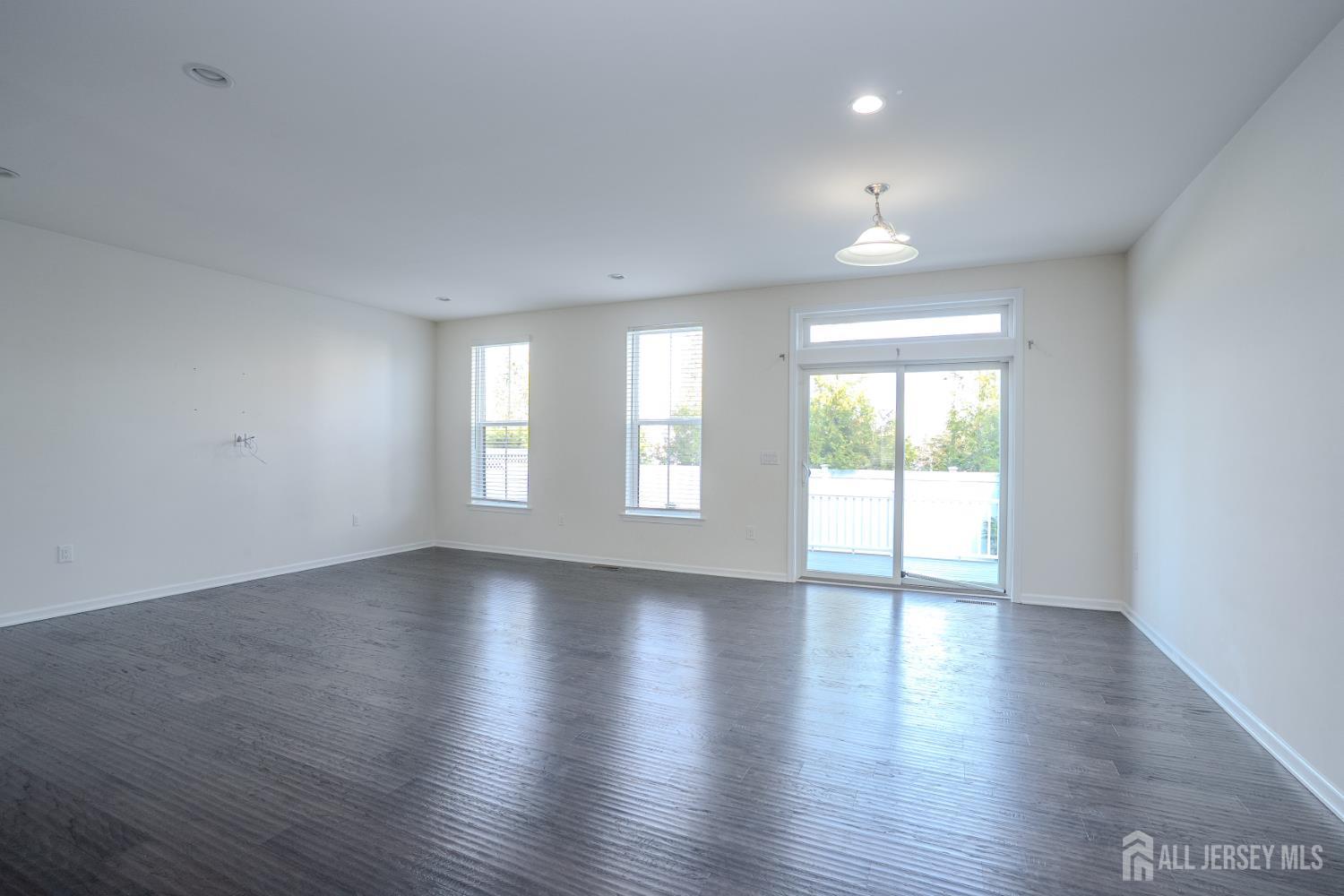 16 Clover Lane Monroe Township, NJ 08831 - Photo 11 of 36 a view of an empty room with wooden floor and a window