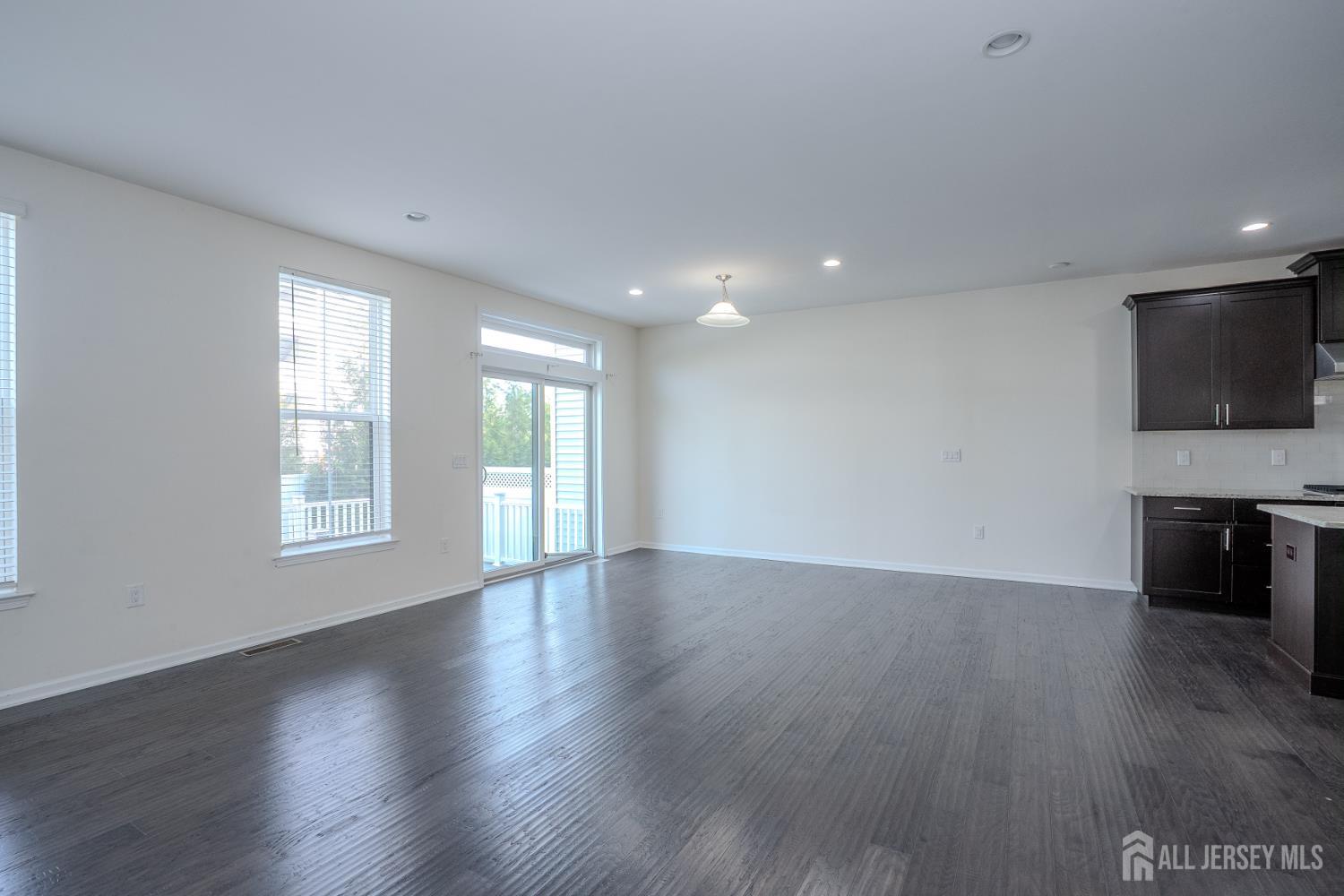 16 Clover Lane Monroe Township, NJ 08831 - Photo 12 of 36 a view of an empty room with wooden floor and a window
