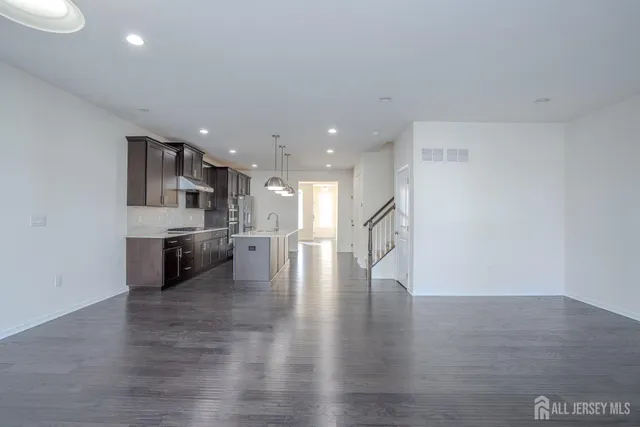 a view of a kitchen with a sink and a large window