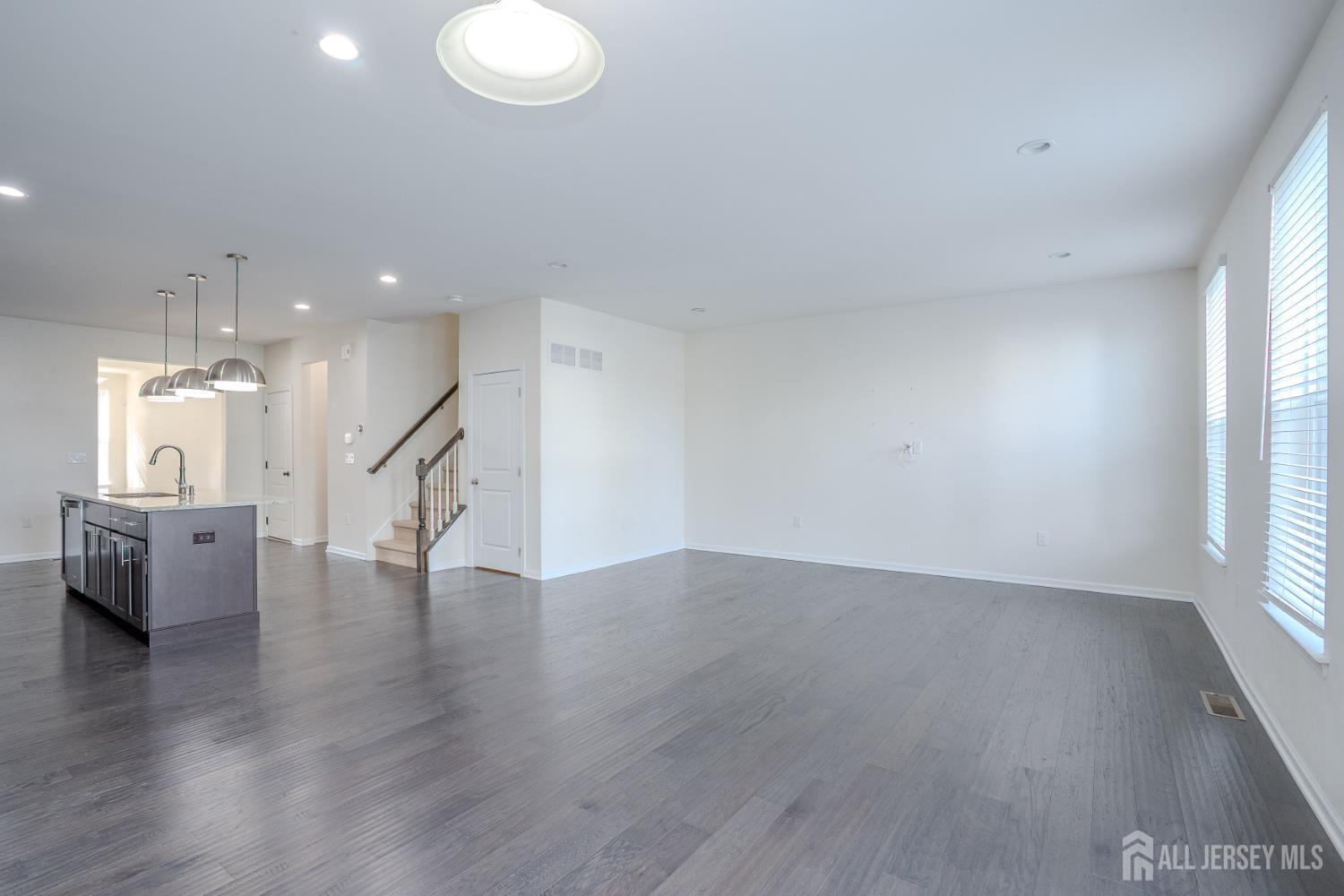 16 Clover Lane Monroe Township, NJ 08831 - Photo 14 of 36 a view of an empty room with wooden floor and a window
