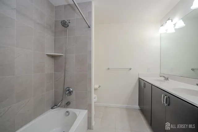 a bathroom with a tub shower vanity and a sink