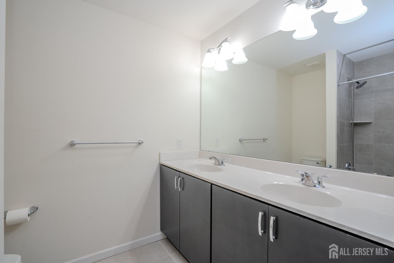 16 Clover Lane Monroe Township, NJ 08831 - Photo 27 of 36 a bathroom with a sink and a mirror