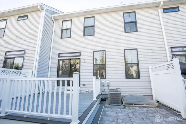 a view of a house with wooden deck