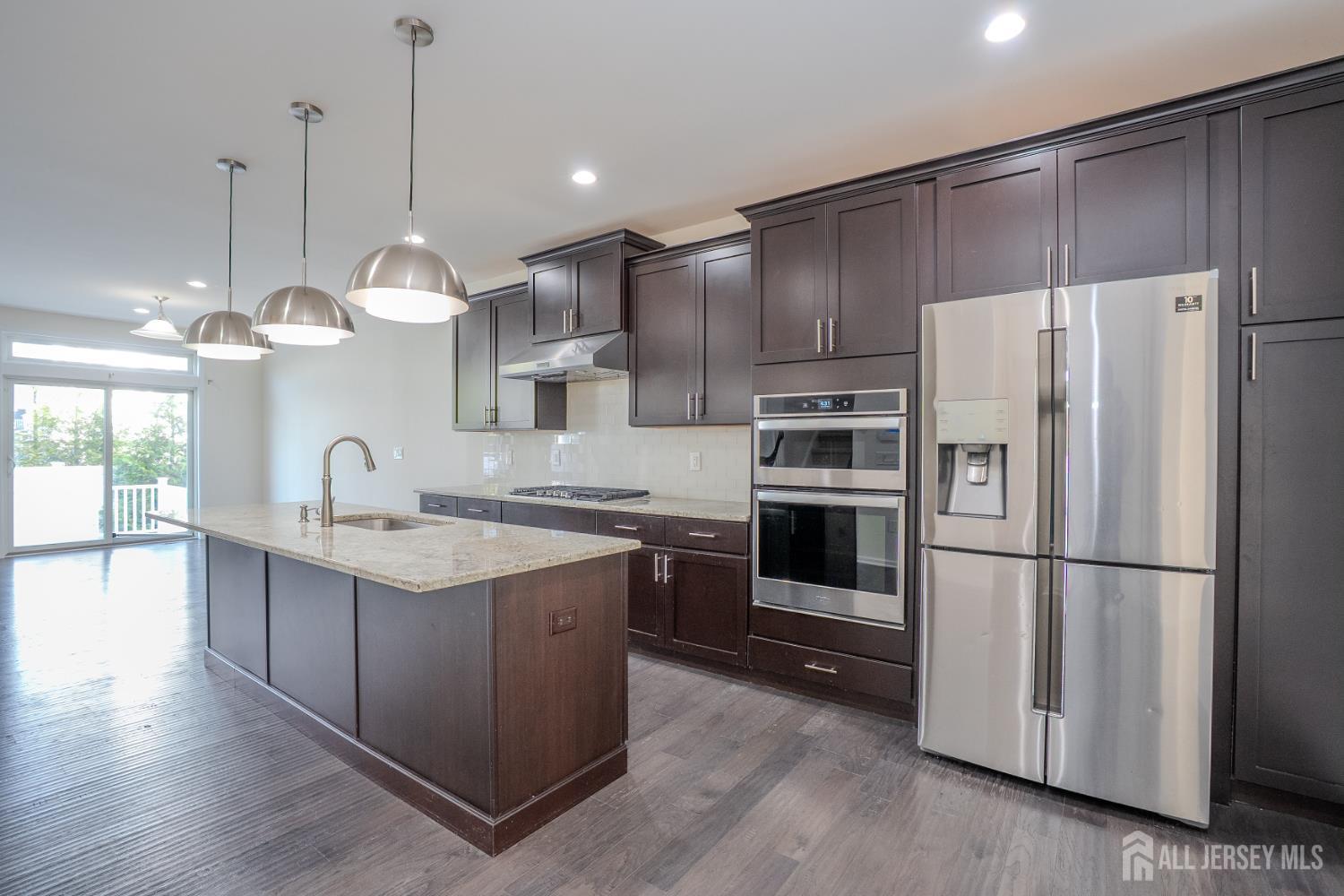 16 Clover Lane Monroe Township, NJ 08831 - Photo 6 of 36 a kitchen with stainless steel appliances granite countertop a refrigerator a sink and a stove