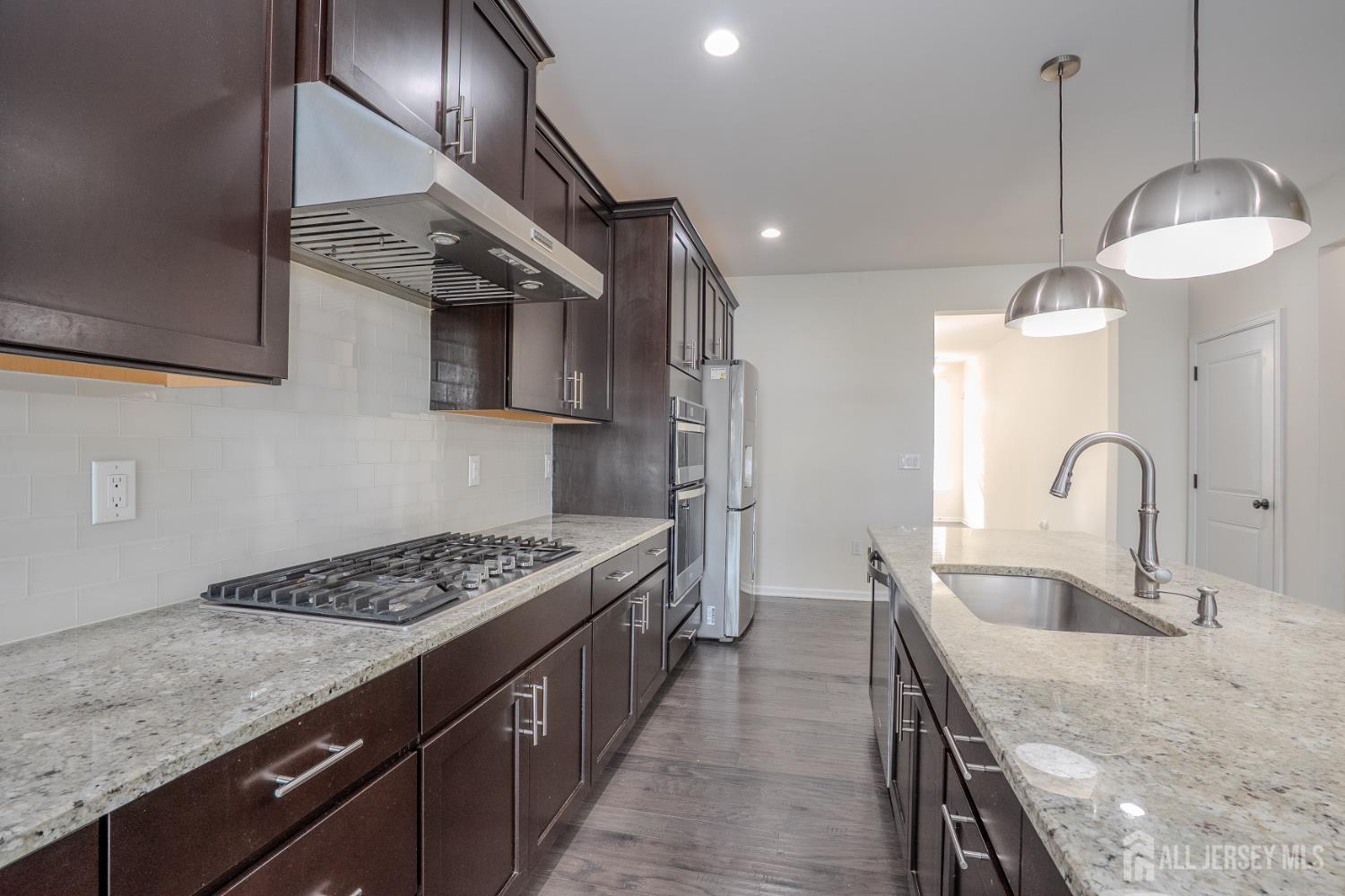 16 Clover Lane Monroe Township, NJ 08831 - Photo 10 of 36 a kitchen with granite countertop a sink stainless steel appliances and cabinets