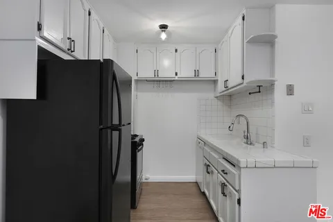 a kitchen with a sink and refrigerator