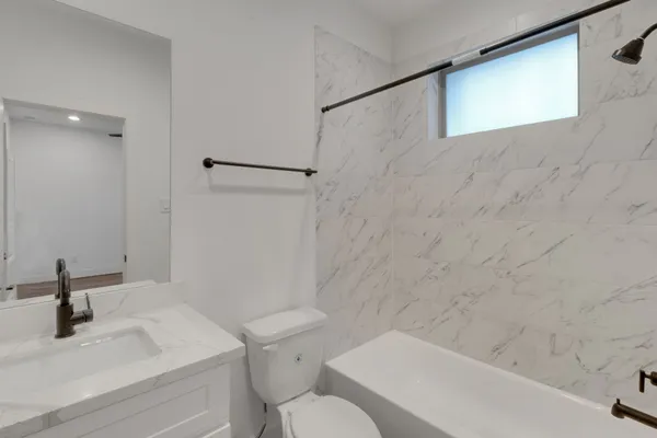 a bathroom with a sink a toilet and a bathtub