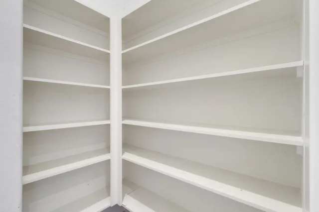 a view of a kitchen with a sink and refrigerator
