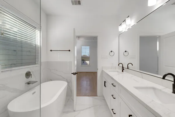 a bathroom with a bathtub and a shower
