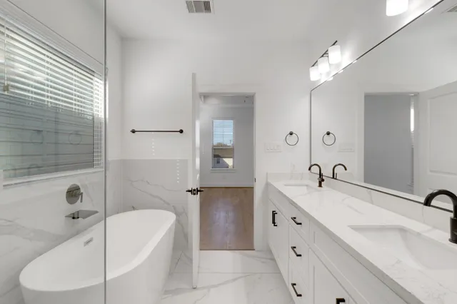 a bathroom with a bathtub and a shower