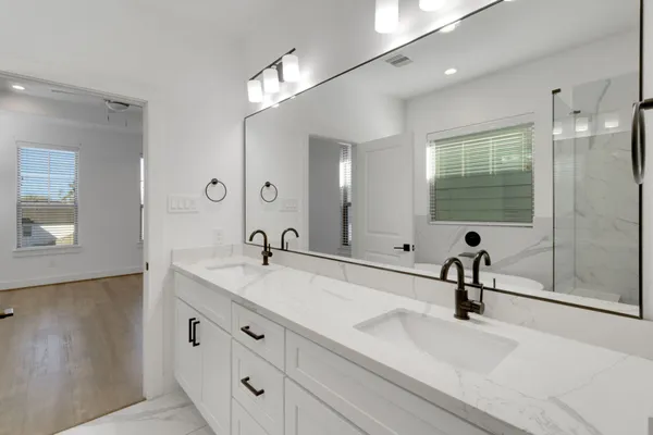 a spacious bathroom with a tub sink and mirror
