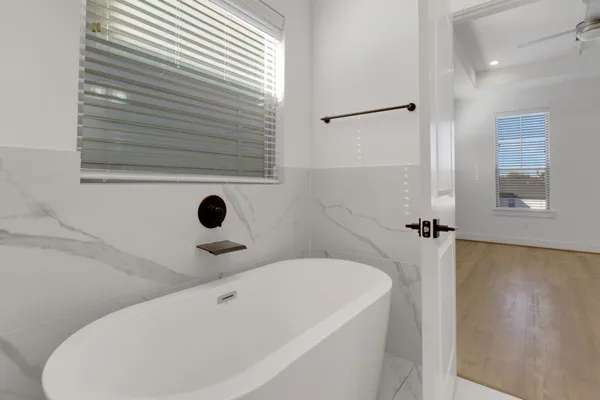 a bathroom with a sink a toilet a mirror and window