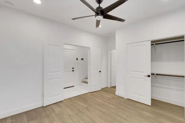 a view of a room with wooden floor and white walls