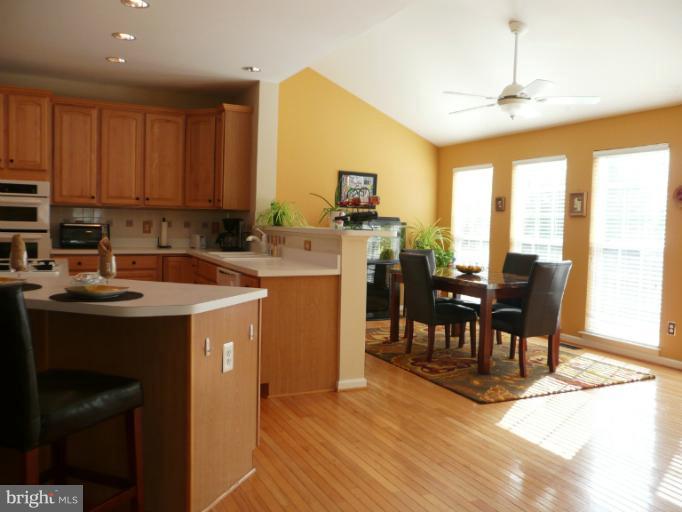 42739 Middle Ridge Place Broadlands, VA 20148 - Photo 2 of 30 a kitchen with sink a microwave and dining table