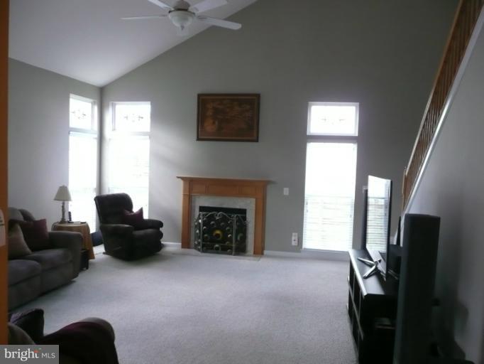 42739 Middle Ridge Place Broadlands, VA 20148 - Photo 16 of 30 a living room with furniture and a fireplace