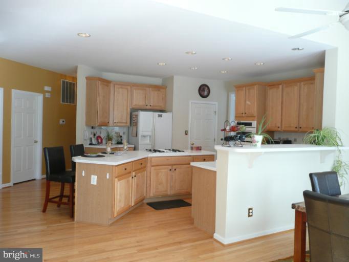 42739 Middle Ridge Place Broadlands, VA 20148 - Photo 20 of 30 a kitchen with granite countertop a sink stove and cabinets