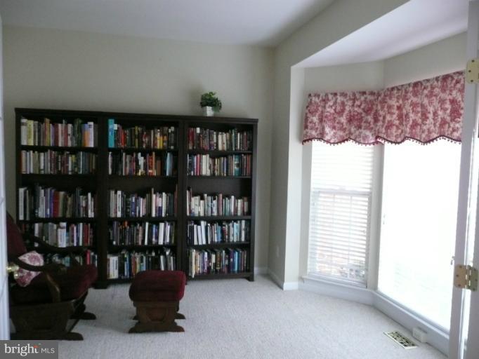 42739 Middle Ridge Place Broadlands, VA 20148 - Photo 3 of 30 a view of a livingroom with book shelf and a window