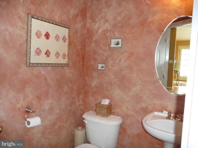 42739 Middle Ridge Place Broadlands, VA 20148 - Photo 22 of 30 a bathroom with a granite countertop toilet and a mirror