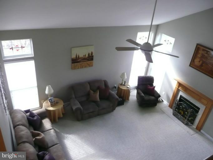 42739 Middle Ridge Place Broadlands, VA 20148 - Photo 7 of 30 a living room with furniture a ceiling fan and a window