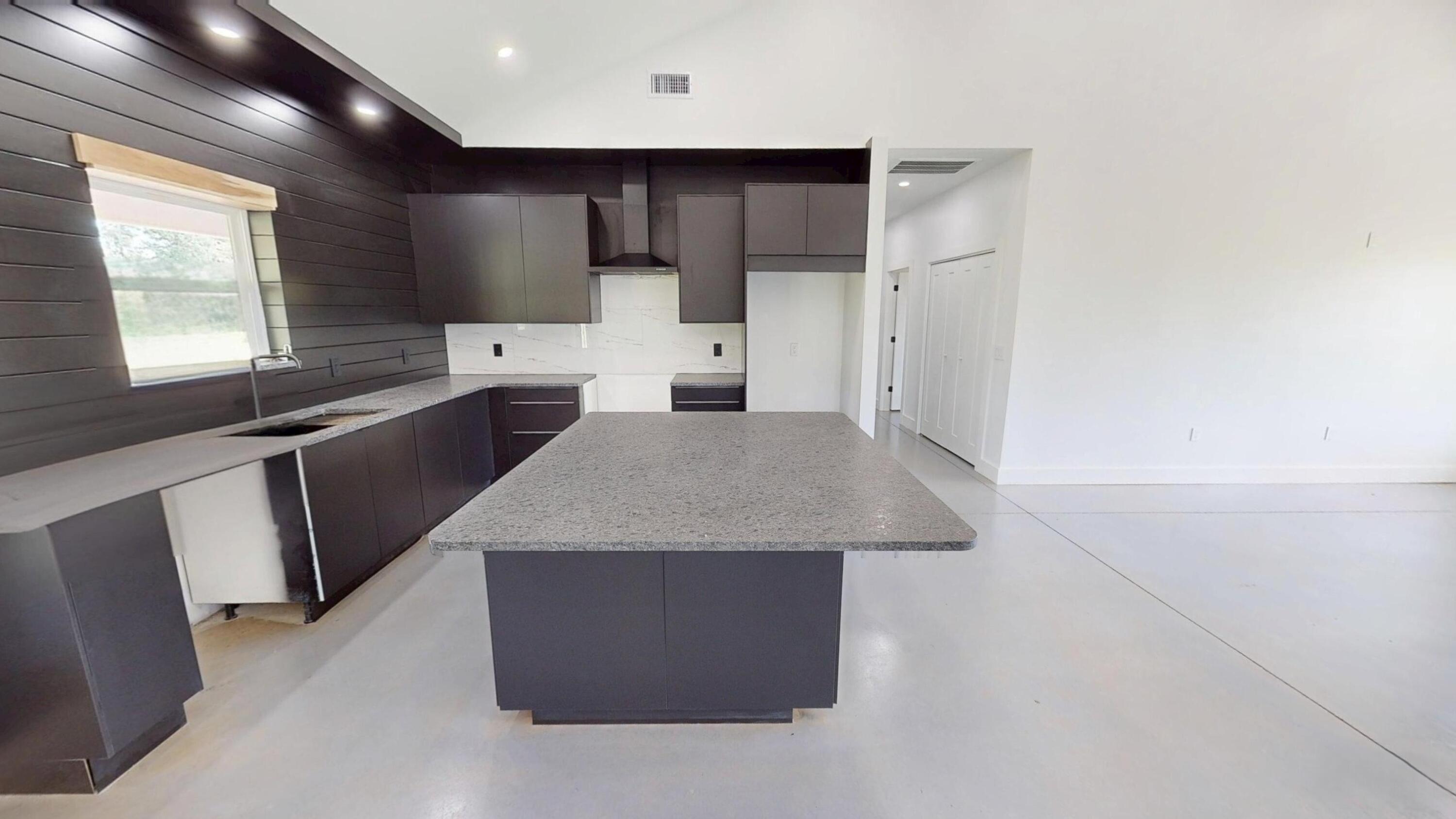37837 Straughn School Road Out Of State, OUT OF STATE 00000 - Photo 21 of 59 a kitchen with stainless steel appliances a sink a stove a refrigerator cabinets and a window