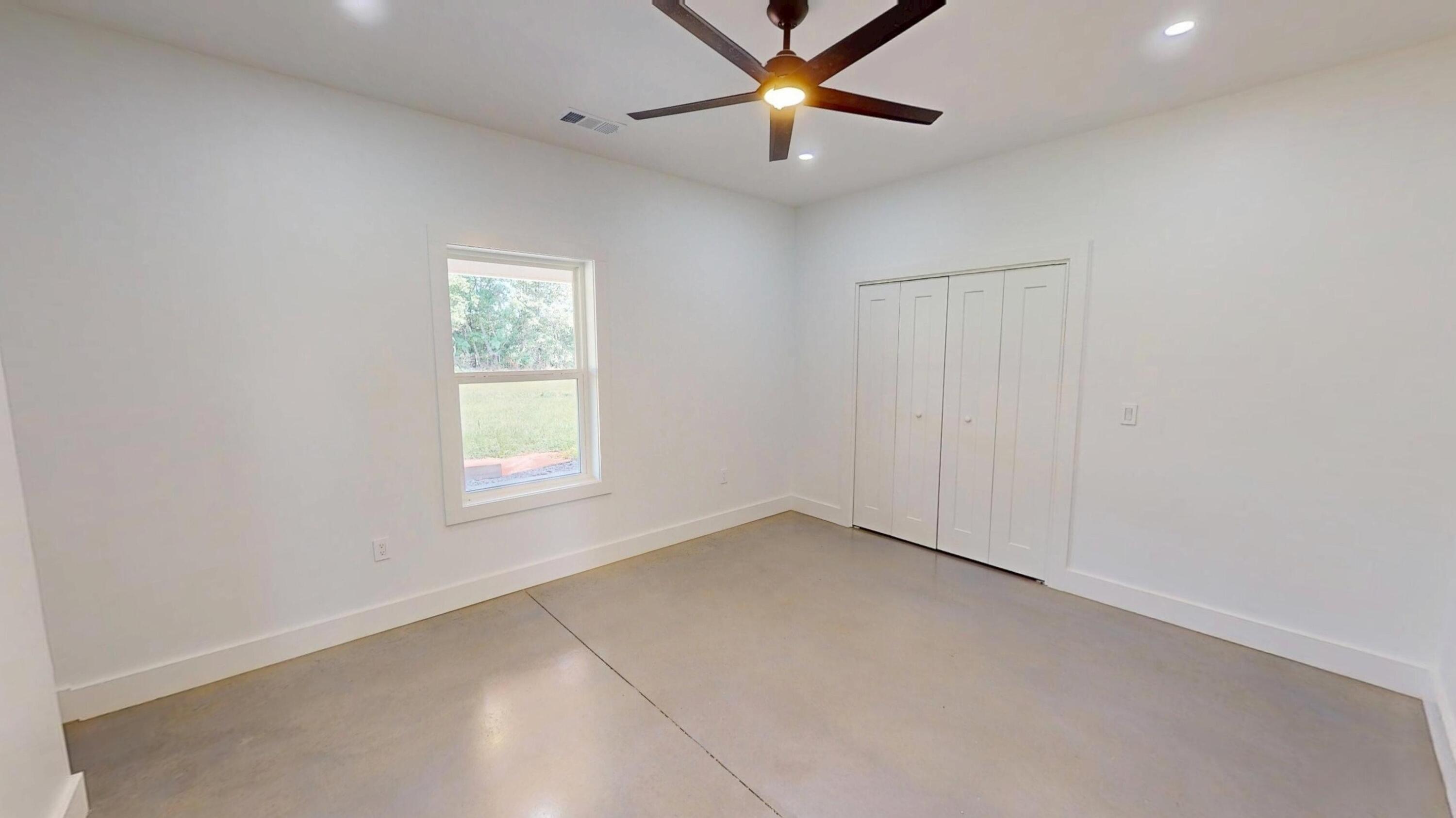 37837 Straughn School Road Out Of State, OUT OF STATE 00000 - Photo 29 of 59 an empty room with a window and a fan