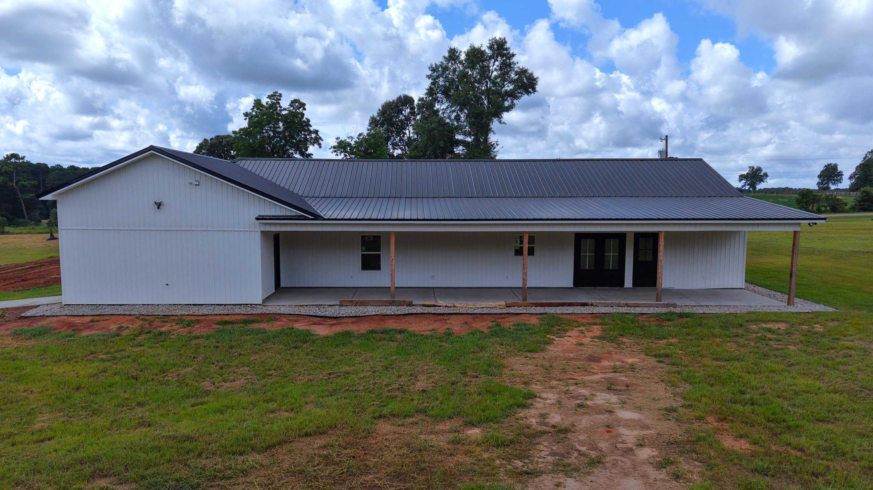 37837 Straughn School Road Out Of State, OUT OF STATE 00000 - Photo 45 of 59 a front view of a house with a yard and garage