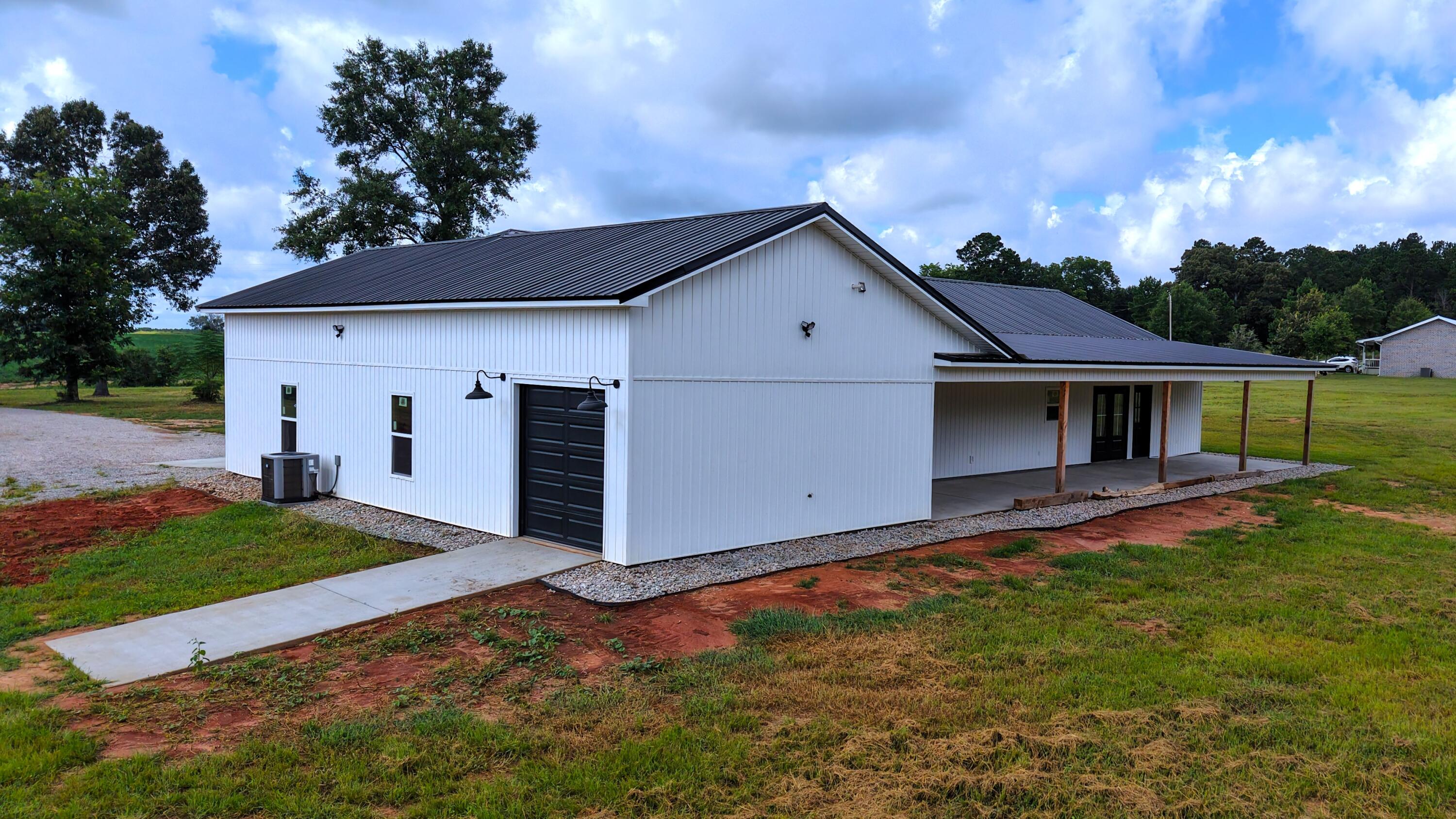 37837 Straughn School Road Out Of State, OUT OF STATE 00000 - Photo 47 of 59 a front view of a house with a yard and garage
