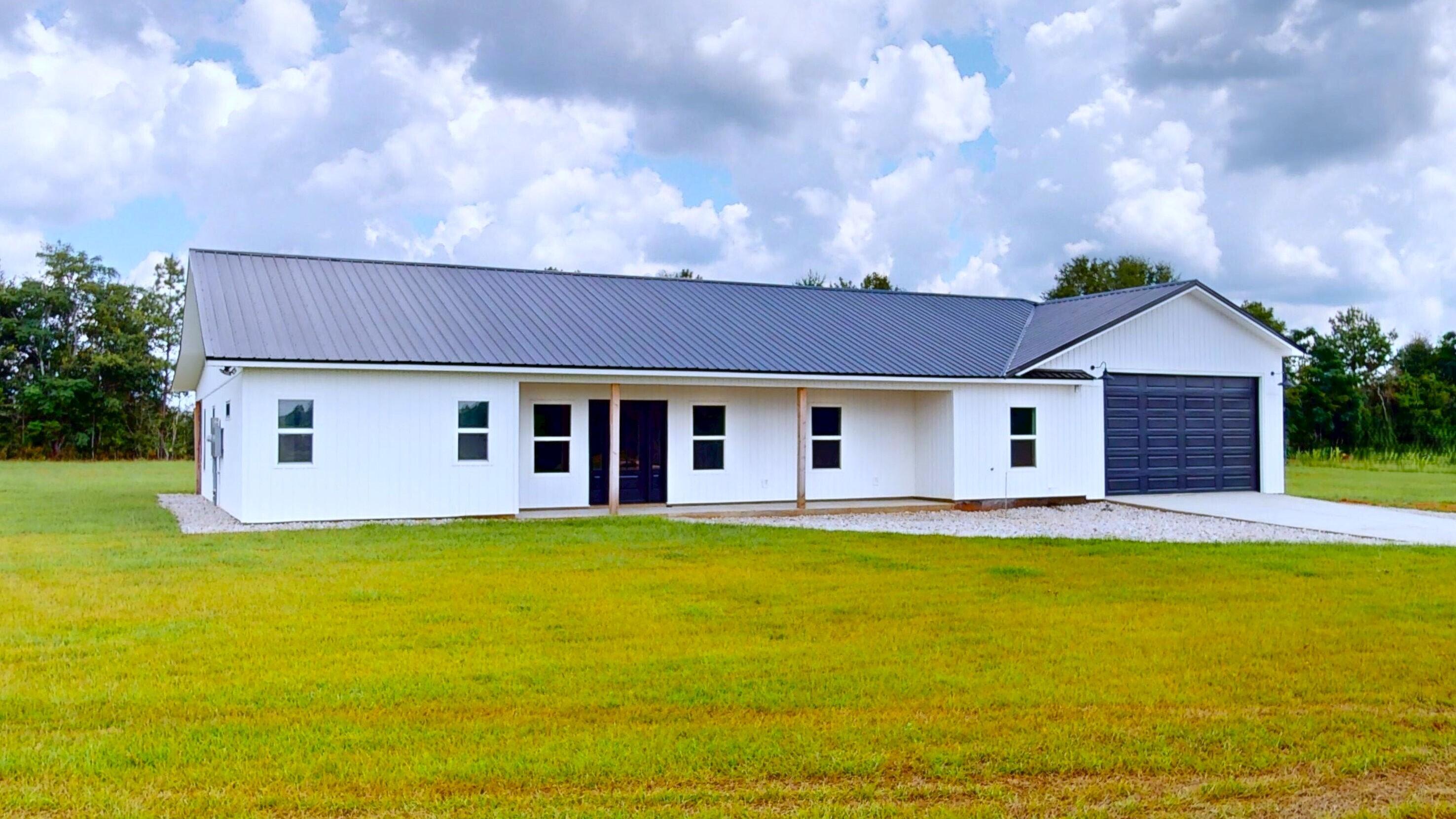37837 Straughn School Road Out Of State, OUT OF STATE 00000 - Photo 5 of 59 a front view of house with yard and trees in the background