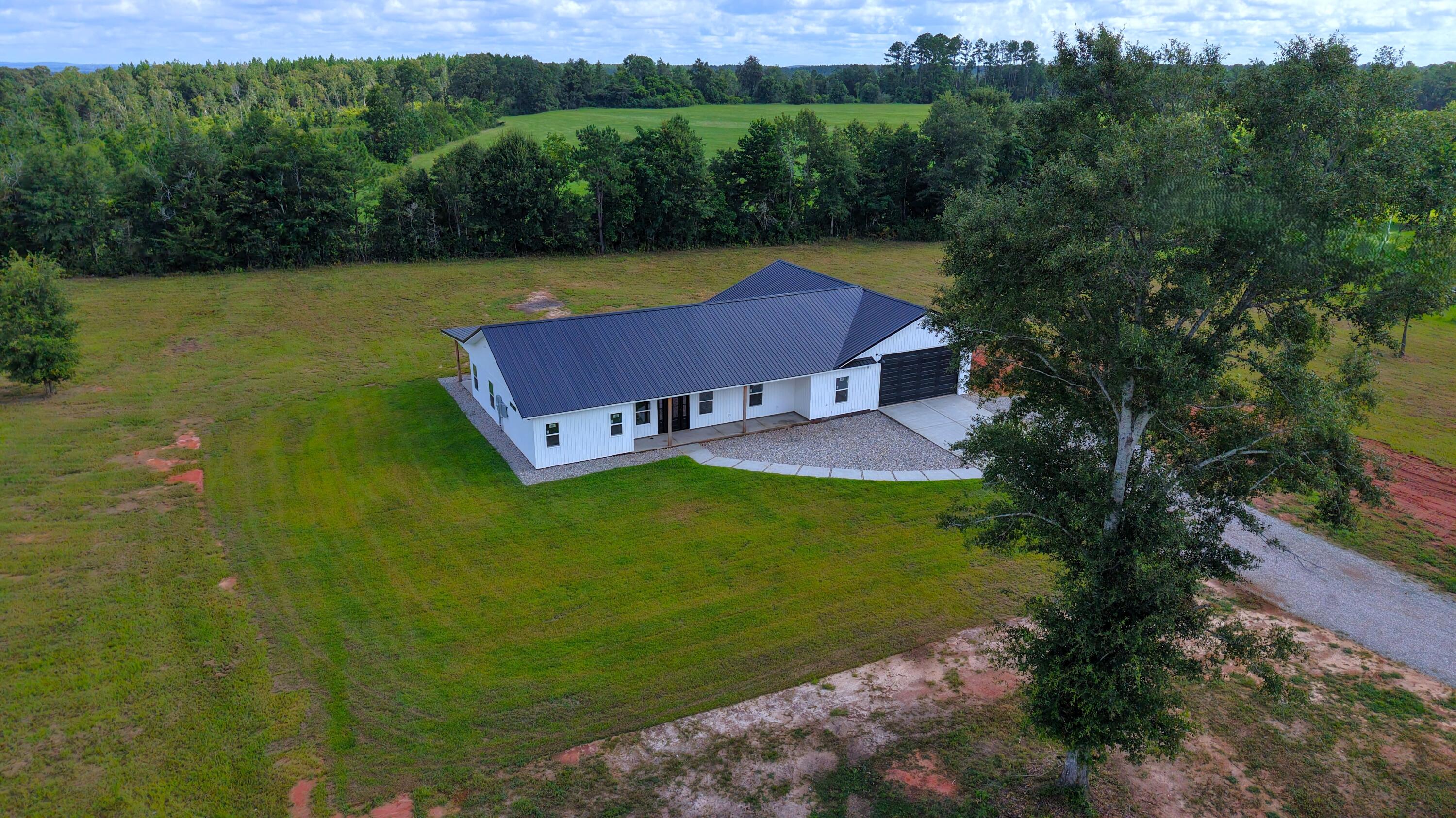 37837 Straughn School Road Out Of State, OUT OF STATE 00000 - Photo 52 of 59 an aerial view of a house with garden space and a lake view