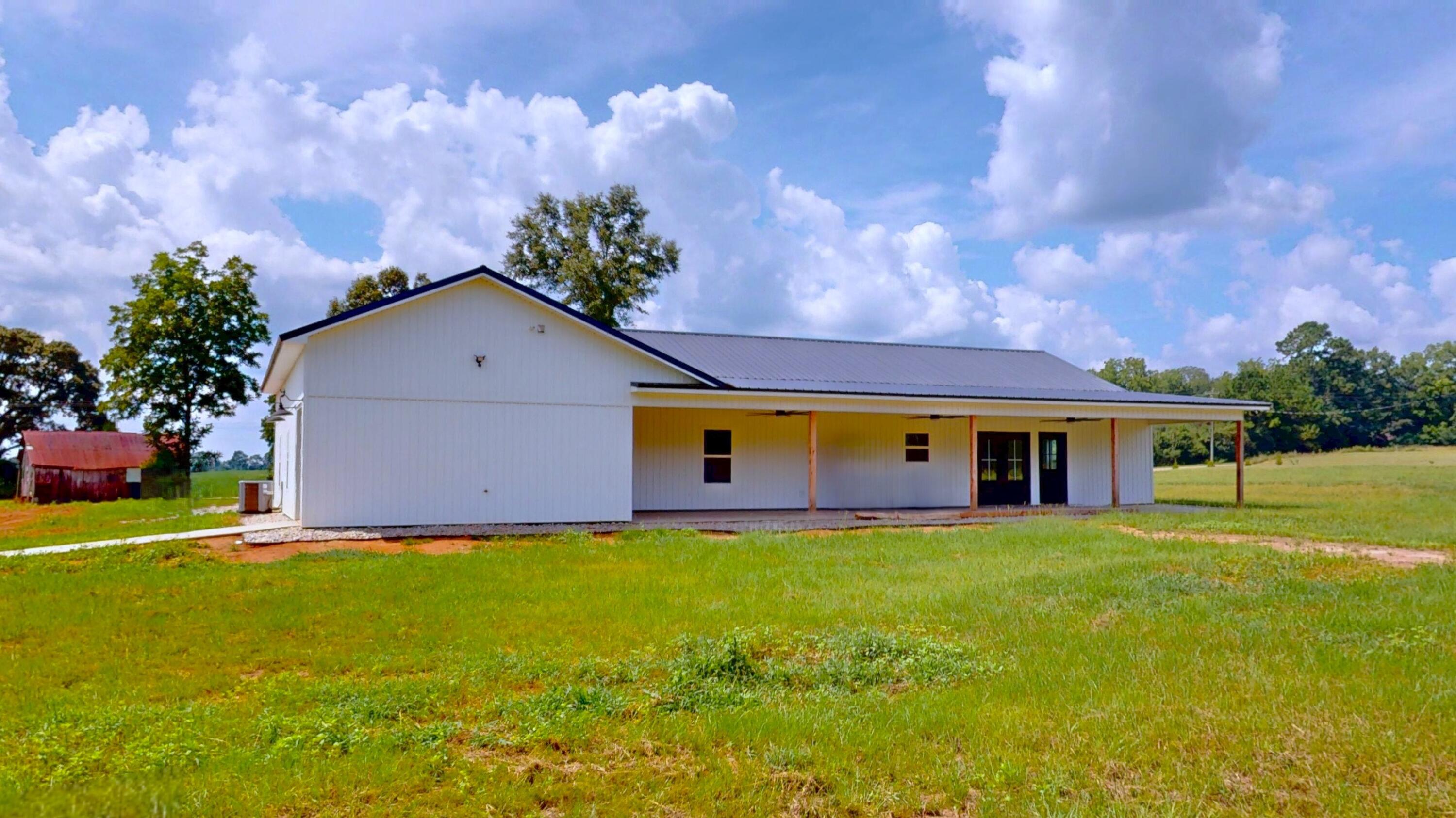 37837 Straughn School Road Out Of State, OUT OF STATE 00000 - Photo 9 of 59 a front view of house with yard and trees in the background