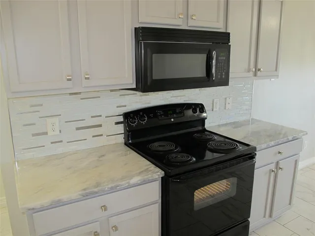 a kitchen with a sink cabinets and stainless steel appliances