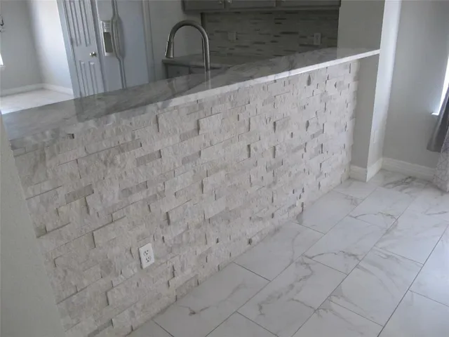 a bathroom with a sink a light fixture and a mirror