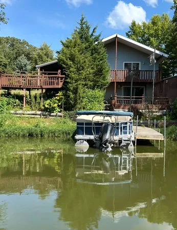 a view of house with garden space house and lake view
