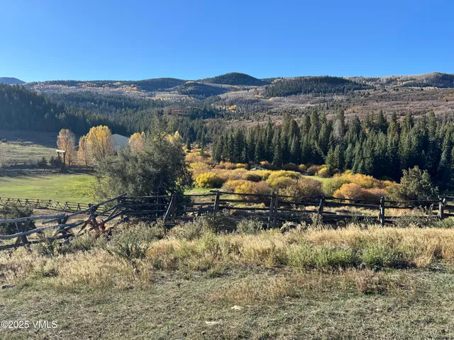 a backyard of a house with a yard and mountain view