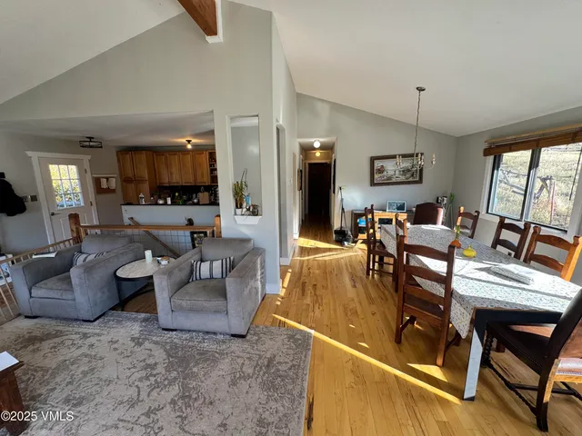 a living room with fireplace furniture and a large window