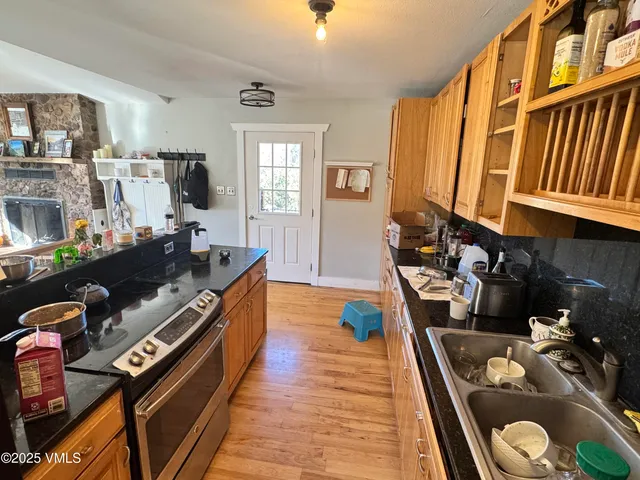 a kitchen with sink stove and cabinets