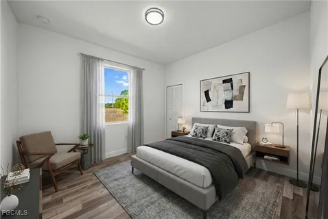 a bedroom with a bed and a chair