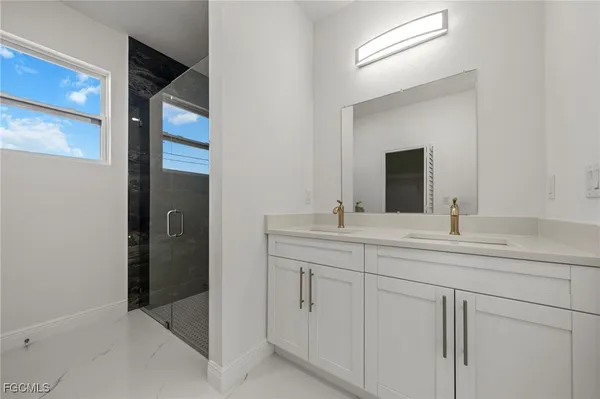 a bathroom with a double vanity sink and mirror