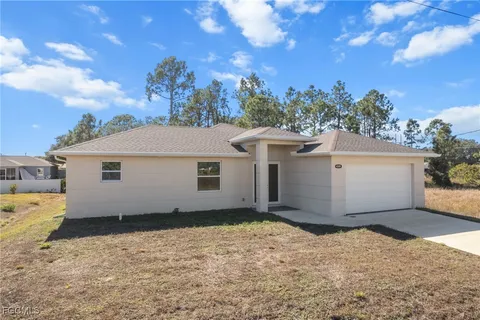 a view of a white house with a yard