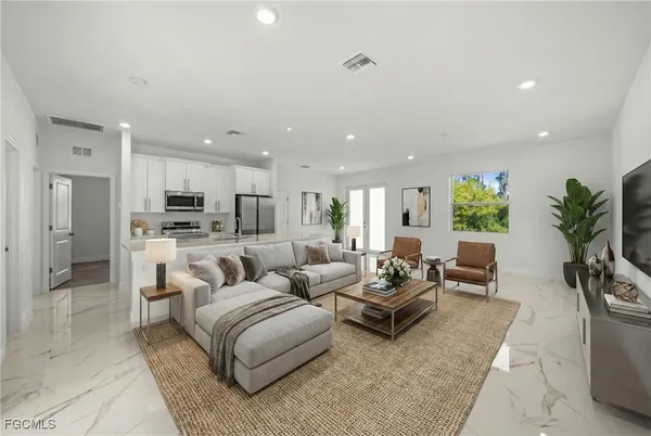 a living room with furniture and a large window