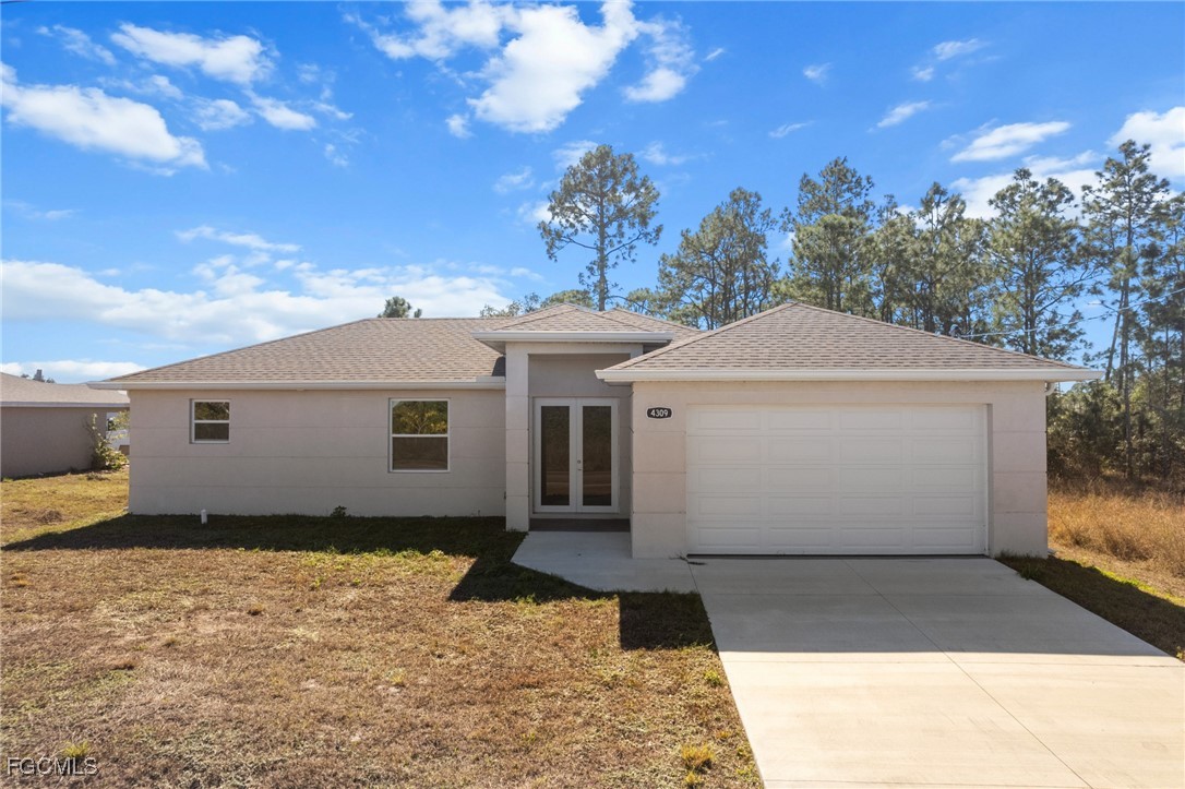 4309 8th Street Southwest Lehigh Acres, FL 33976 - Photo 21 of 25 a view of a white house with a yard