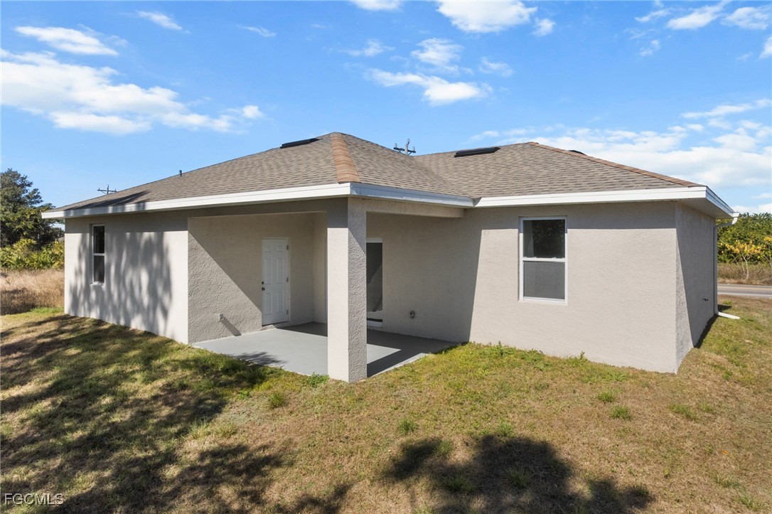 4309 8th Street Southwest Lehigh Acres, FL 33976 - Photo 23 of 25 a front view of a house with a yard