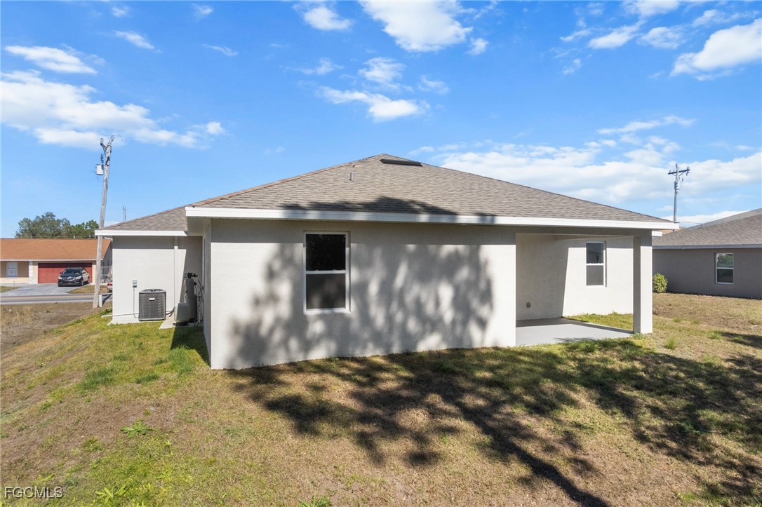 4309 8th Street Southwest Lehigh Acres, FL 33976 - Photo 24 of 25 a front view of a house with garden