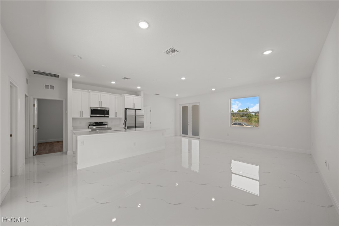 4309 8th Street Southwest Lehigh Acres, FL 33976 - Photo 4 of 25 a view of kitchen with stainless steel appliances refrigerator oven