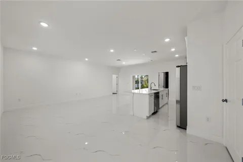 a view of a living room and kitchen with furniture