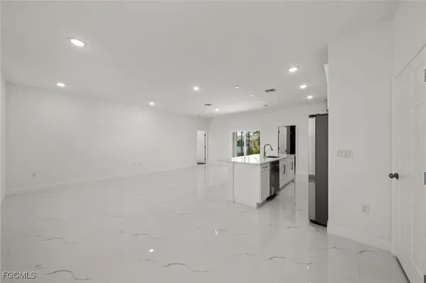 a view of a living room and kitchen with furniture
