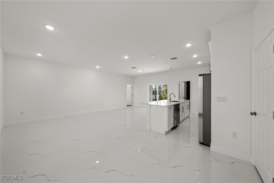 4309 8th Street Southwest Lehigh Acres, FL 33976 - Photo 5 of 25 a view of a living room and kitchen with furniture